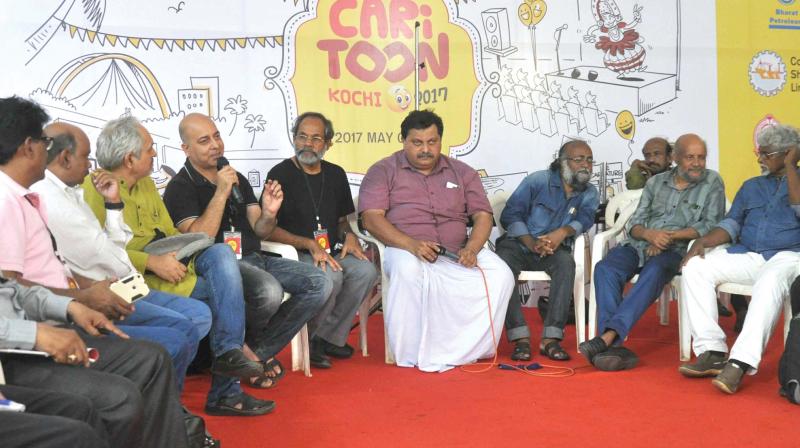 Cartoonists take part in the event Toon Talk held as part of cariToon 2017.