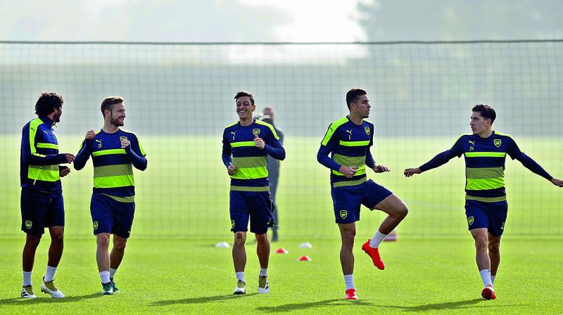 Arsenals Mohamed Elneny (from left), Shkodran Mustafi, Mesut Ozil, Gabriel and Hector Bellerin warm-up at a practice session at the clubs complex in London on Monday, ahead of their Uefa Champions League Group A match against Ludogorets Razgrad. (Photo: AFP)
