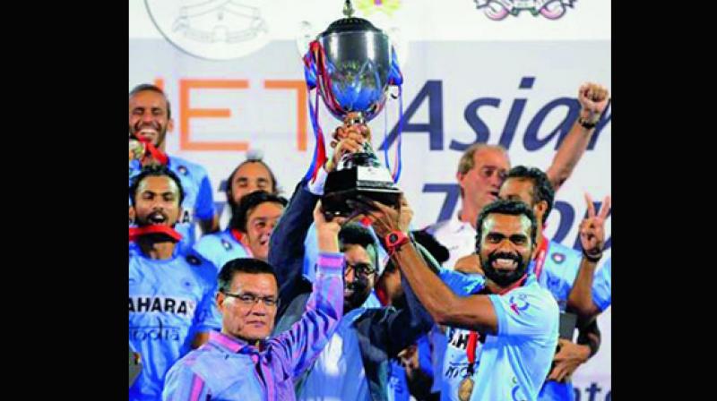 Skipper Sreejesh P.R. lifts the winners trophy after clinching the Asian Champions Trophy in Kuantan, Malaysia, on Sunday. India beat Pakistan 3-2 in the final.