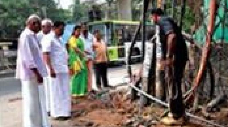 Corporations works committee chairman P.M. Haris inspects the site where a private telecom company was cutting the road for cable-laying without required permission on Thursday.