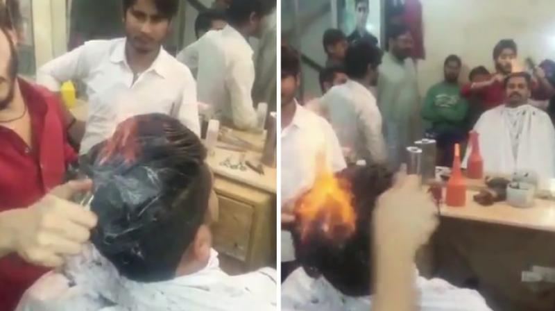 The barber applies a cream and powder and styles the hair while it is on fire. (Photo: Twitter)
