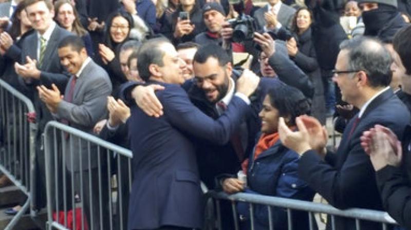 In this image made from a video, former U.S. Attorney for the Southern District of New York, Preet Bharara, walks down a line of applauding well-wishers  in front of the New York office where he worked until he was fired by President Donald Trumps administration over the weekend after refusing to resign. (Photo: AP)