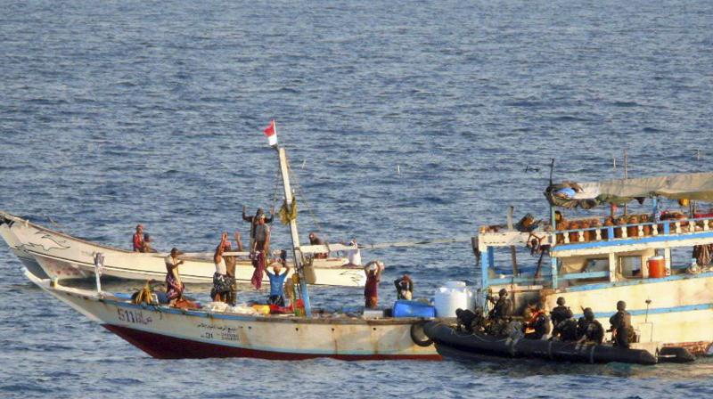 The Indian Navy men secure skiffs in their operation on Tuesday to thwart a piracy attempt on a Liberian vessel in the Gulf of Aden. (Photo: PTI)