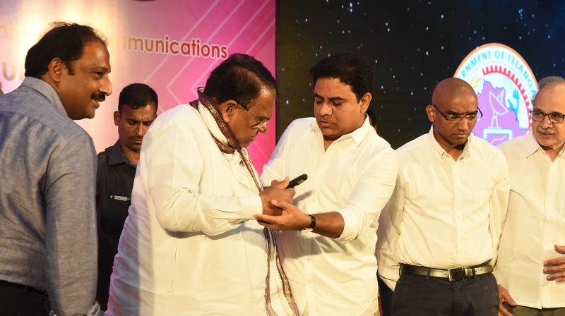 Minister K.T Rama Rao guides minister Pocharam Srinivas Reddy during the T-SAT telivision channel launch held at ITC Kakatiya hotel on Wednesday. (Photo: DC)