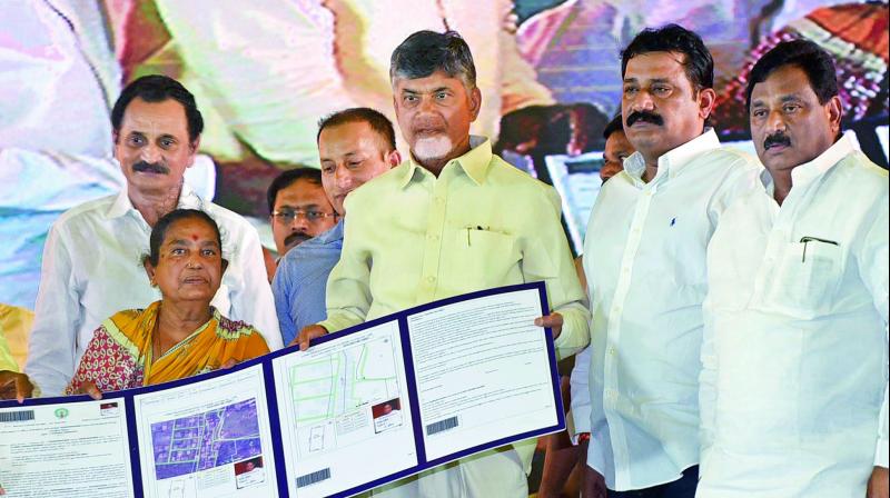 Chief Minister Nara Chandrababu Naidu distributes pattas (title deeds) to beneficiaries during the 2nd phase of patta distribution programme at Steel Plant Pragati Maidan in Visakhapatnam on Wednesday. (Photo: DC)