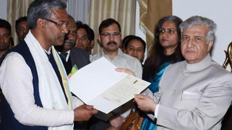 Uttarakhand Governor Krishna Kant Paul appointed BJP Legislative Party leader Trivendra Singh Rawat as CM and invited him to form government. (Photo: ANI Twitter)
