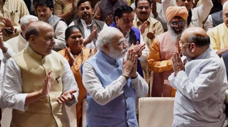 Prime Minister Narendra Modi, Home Minister Rajnath Singh and BJP President Amit Shah greet party members during the BJP Parliamentary party meeting at Parliament house in New Delhi. (Photo: PTI)