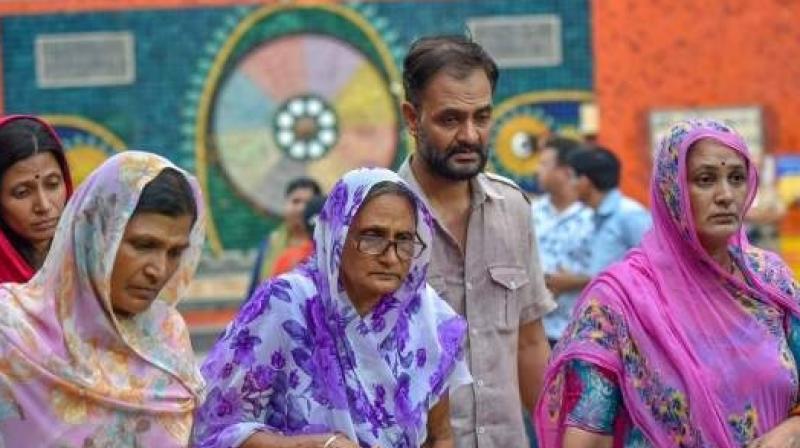 Relatives mourn during cremation of the 11 members of a family who were found hanging in their house in Burari at Nigambodh Ghat in New Delhi on Monday July 2 2018. (Photo: PTI)