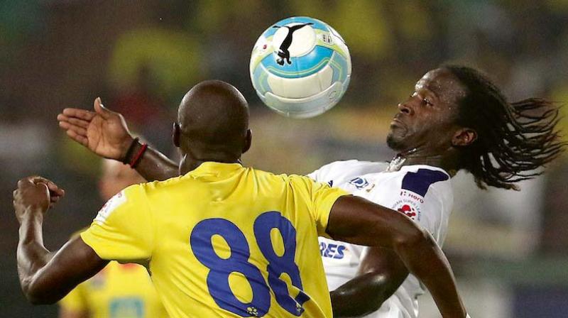 Chennayin FCs Bernard Mendy (right) and Azrack Mahamat of Kerala Blasters vie for the ball in their ISL-3 match in Kochi on Saturday. Blasters won 3-1.