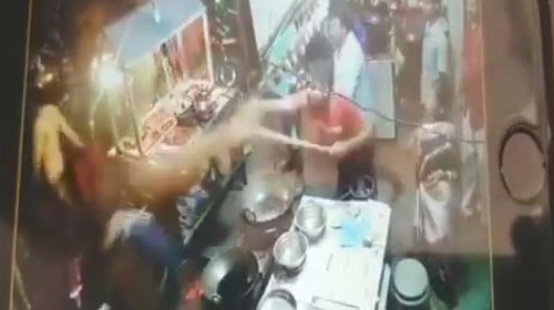 In the video, the customer is seen throwing an object at the staff, who retaliated by throwing hot oil at him. (Photo: Screengrab/ANI)