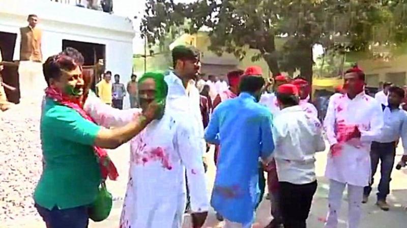 Samajwadi Party workers and leaders celebrate outside party headquarters in Uttar Pradesh. have already started celebrating their victory