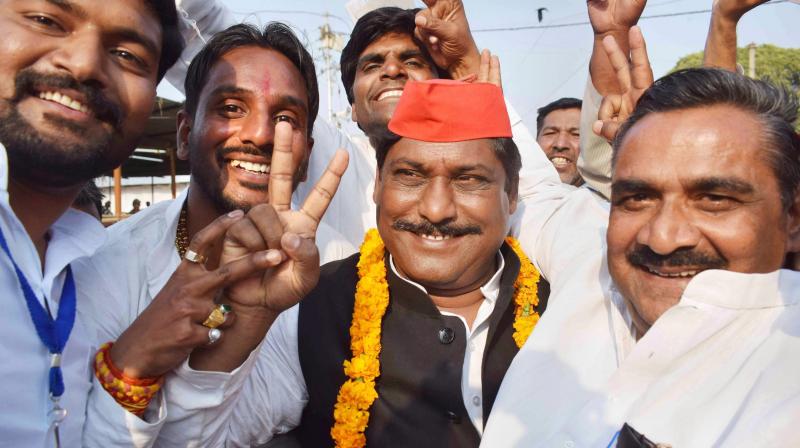 Samajwadi Party candidate Nagendra Pratap Singh Patel flashes a victory sign after the Phulpur Lok Sabha bypoll election results, in Allahabad. (Photo: PTI)