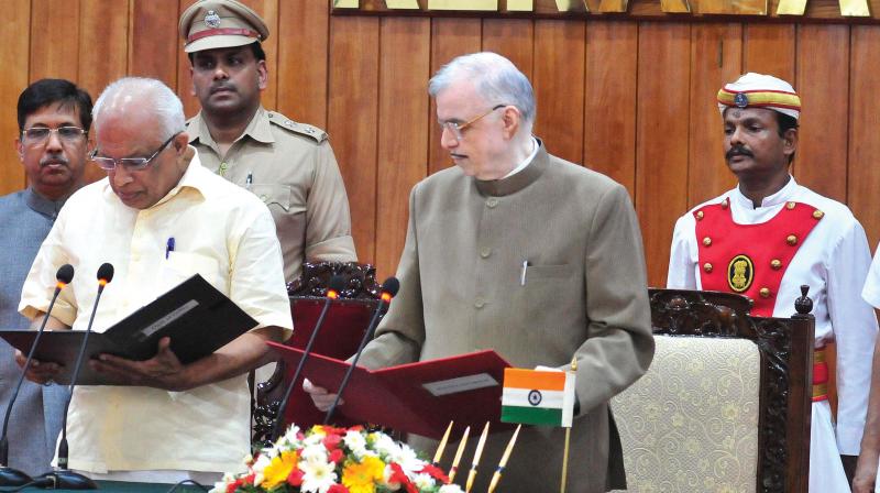 Governor P. Sathasivam administers the oath of office and secrecy to K. Krishnankutty at the Raj Bhavan in Thiruvananthapuram on Tuesday. (Photo:  A.V. MUZAFAR)
