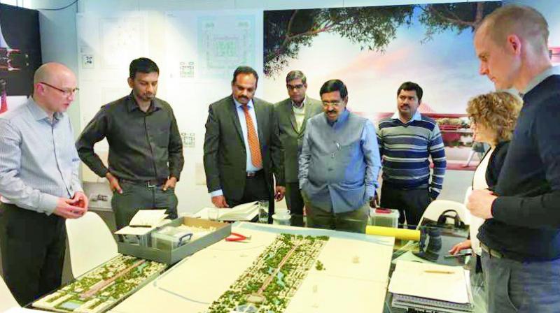 Minister P. Narayana and CRDA commissioner Cherukuri Sridhar watch the Norman Foster designs of the Amaravati capital region at London on Thursday.