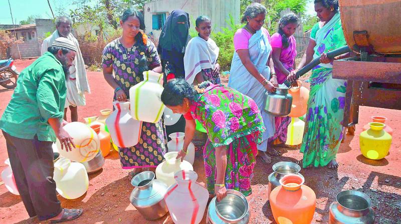 Residents collect water from a water tank in Giddalur town in Prakasam district on Thursday.