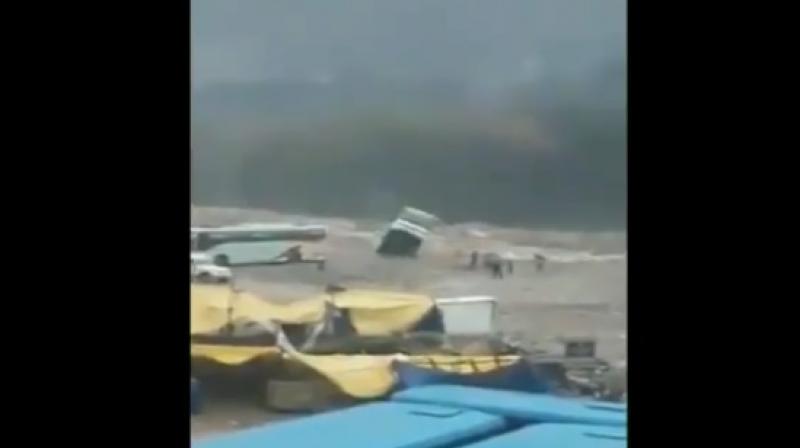 The bus was empty when it was washed away into the flooded Beas River. (Photo: Screengrab | ANI)