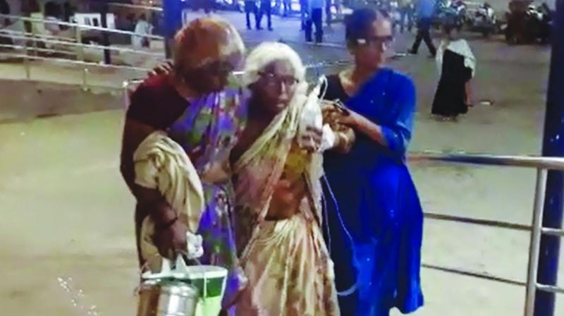 No mercy: Magamma, 85, with the help of her neighbour Waralakshmi and daughter Satamma is forced to walk up the ramp to the outpatient wing at Gandhi Hospital with her IV fluid in hand.