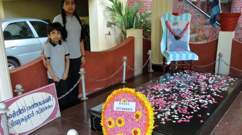 Sivapriya R. Pillai and Rudraksh R. Pillai, the niece and nephew of Kargil martyr  M.O. Shijukumar near his memorial outside his house at Vazhuthacaud.  	 Peethambaran Payyeri