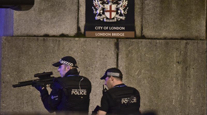 An armed Police officer looks through his weapon on London Bridge in London. (Photo: AP)