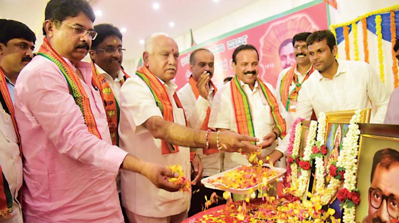 BJP leaders B.S. Yeddyurappa, D.V. Sadananda Gowda and R. Ashok inaugurate a meeting of the city unit of the party in Bengaluru on Saturday. (Photo: DC)