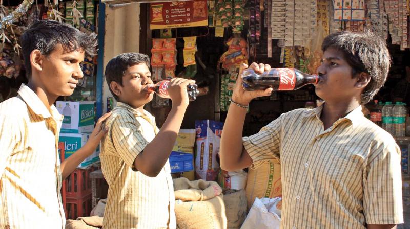 Students take a sip of Coca Cola on a hot day in Pallavaram  (Photo: DC)