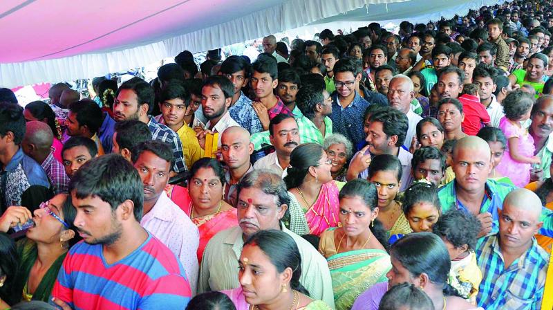 Parents perform Aksharabhyasam to their children at Trisakthi peetham on the occasion of Moola Nakshathram in Vijayawada on Wednesday.