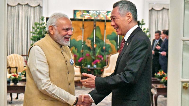 Prime Minister Narendra Modi  shakes hands with Singapores Prime Minister Lee Hsien Loong during a meeting at the Istana presidential palace in Singapore on Friday.  (Photo:AFP)