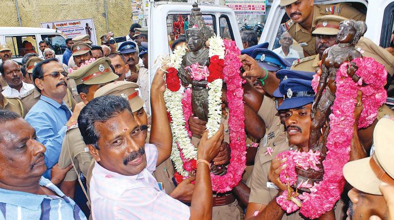 People of Kumbakonam garland the icons of King Raja Raja Chola and Lokamadevi to welcome them back after 50 years at the temple town on Friday.