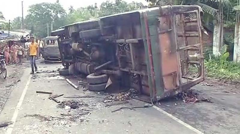 Protesters torch bus in Basirhat, West Bengal. (Photo: Twitter | ANI)