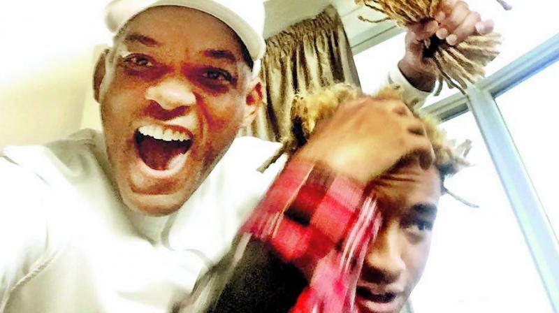 Teamwork: Will Smith poses with Jadens dreads that he chopped off