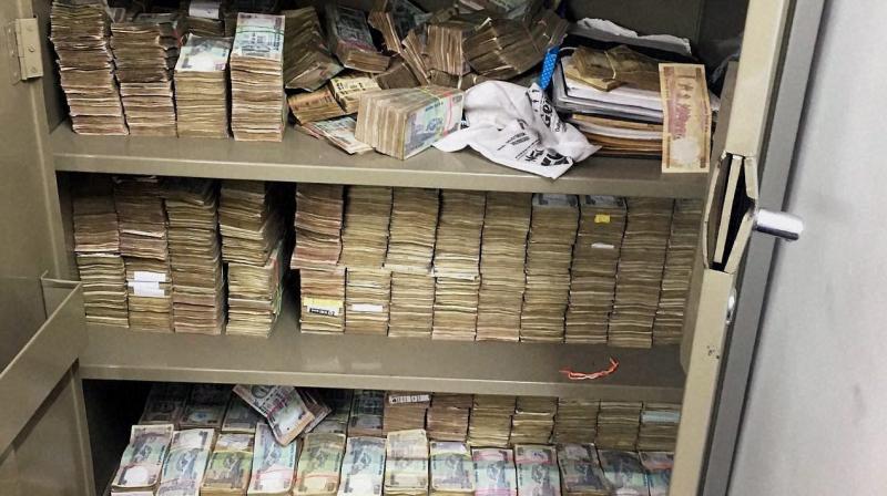 Stacks of currency notes that was found at Rohit Tandons Greater Kailash residence during a raid by Delhi Police crime branch. (Photo: PTI)