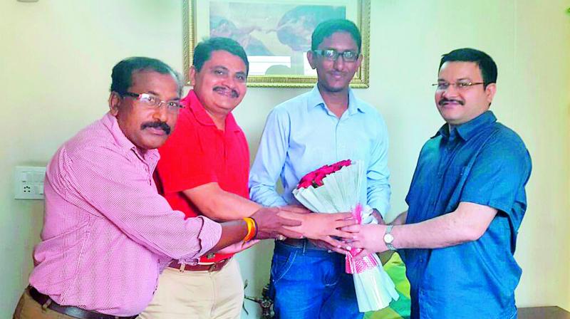 proud mentor: IPS Mahesh M. Bhagwat and IPS Anil Kumar presenting a bouquet to one of his students, Ajit Roy, who got the 900th rank in UPSC 2016 examinations