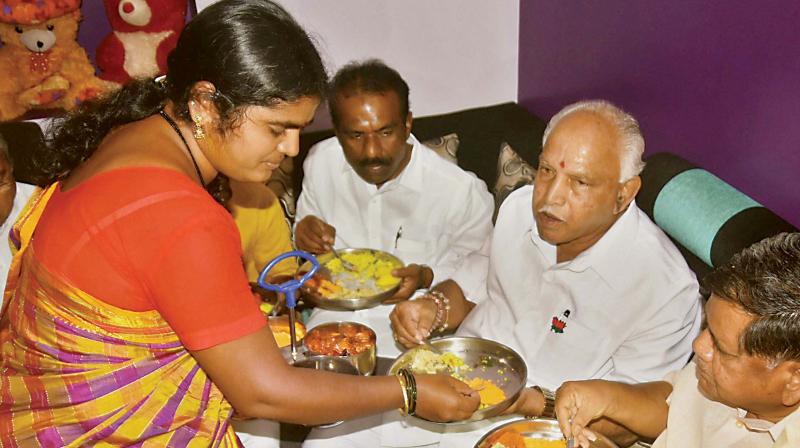 BJP leader B.S. Yeddyurappa has breakfast at a Dalits house in Hubballi on Thursday