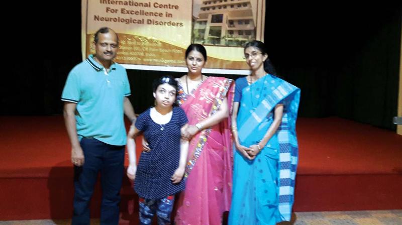 Remya with her parents and doctor (second from right)