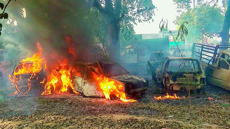 Vehicles set on fire by a mob during a protest over the alleged illegal slaughter of cattle, in Bulandshahr on Monday.  (PTI)