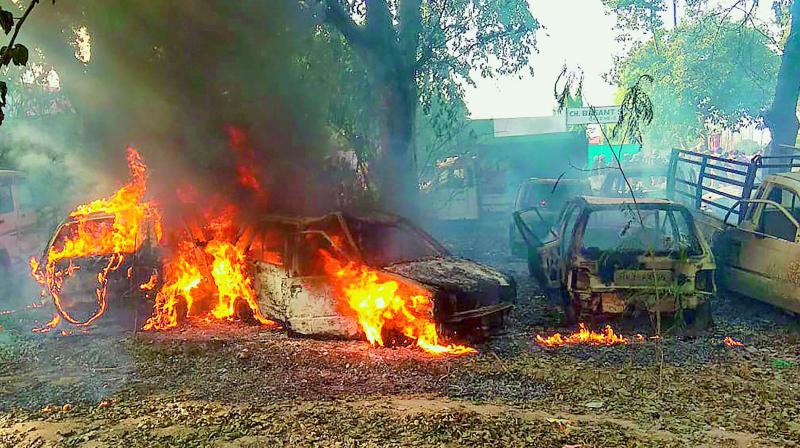 Vehicles set on fire by a mob during a protest over the alleged illegal slaughter of cattle, in Bulandshahr on Monday. (PTI) Vehicles set on fire by a mob during a protest over the alleged illegal slaughter of cattle, in Bulandshahr on Monday. (PTI)