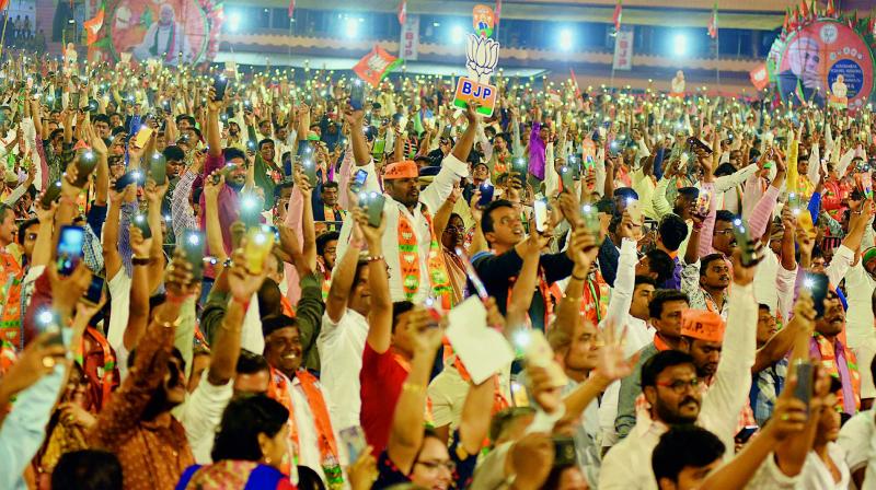 Supporters of BJP switch on torches on their phones in support of Prime Minister Narendra Modi during his speech at LB Stadium on Monday.   (S. Surender Reddy)
