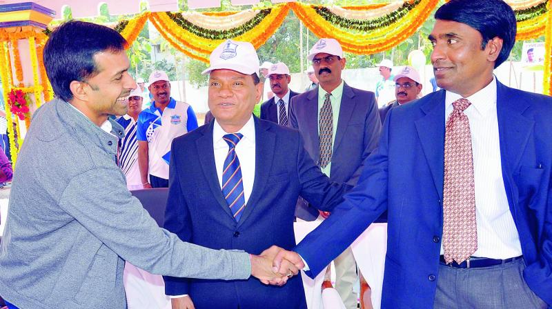 Badminton coach Pullela Gopichand greets Disaster Response Fire Services Director-General M. Gopi Krishna (right) and Prisons Director-General V.K. Singh (Centre) during the opening ceremony of 5th Prisons Sports Meet, 2018, at SICA Parade Ground in Chanchalguda on Monday.    (DC)