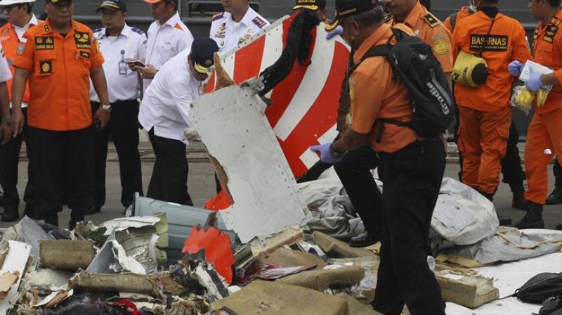 A rescuer inspects a part of Lion Air plane flight JT 610 retrieved from the waters where it crashed at Tanjung Priok Port in Jakarta, Indonesia, in October (Photo: AP)