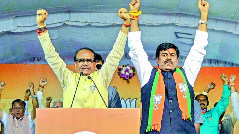 Madhya Pradesh chief minister Shivraj Singh Chouhan campaigns in support of BJP candidate Rameshwar Sharma, in Bhopal, Monday. (PTI)
