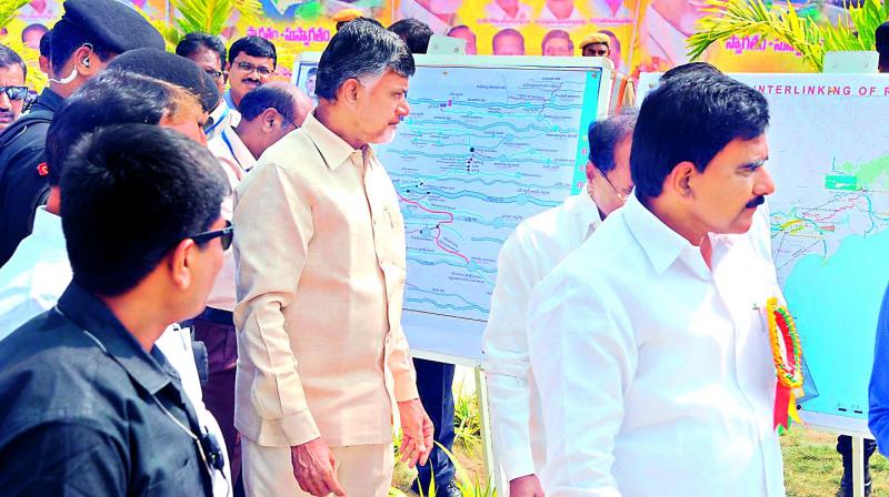 AP Chief Minister N. Chandrababu Naidu and minister for irrigation D. Uma Maheshwara Rao go through the project maps during foundation stone laying ceremony of first phase of inter-linking Godavari-Penna rivers  at Nekarikallu village of Guntur district on Monday.  (DECCAN CHRONICLE)