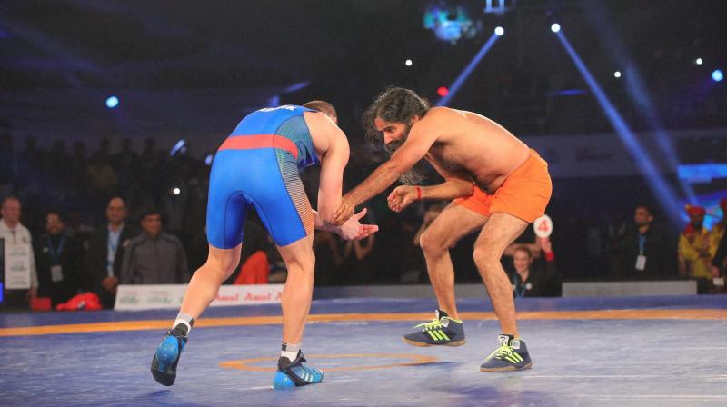 Baba Ramdev, who performed Surya Namaskar before starting his bout, defeated Andrey Stadnik 12-0 in the promotional bout of the 2017 Pro Wrestling League. (Photo: PTI)