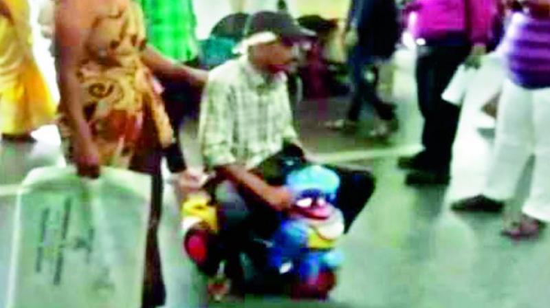 On Thursday, at Gandhi hospital, patient Sarikonda Raju (right) was forced to use a toy car instead of a wheelchair when his wife refused to pay attenders Rs 100 as a bribe. The video of the incident went viral triggering widespread outrage on Friday.