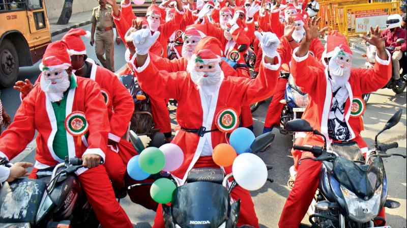 People dressed as Santa Claus  participate in a bike rally at Santhome on Christmas eve on Saturday.