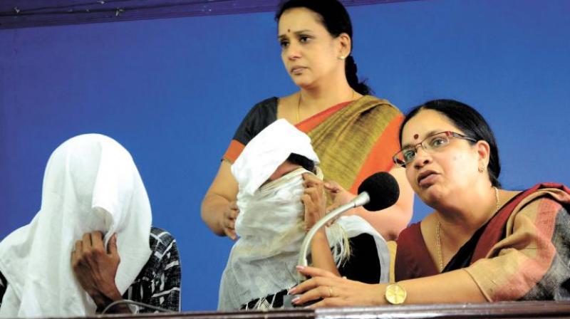 Dubbing artiste Bhagyalakshmi and actor Mala Parvathy along with the gangrape victim and her husband (wearing masks) at a press meet in Thiruvananthapuram on Thursday (Photo: Peethambaran Payyeri)