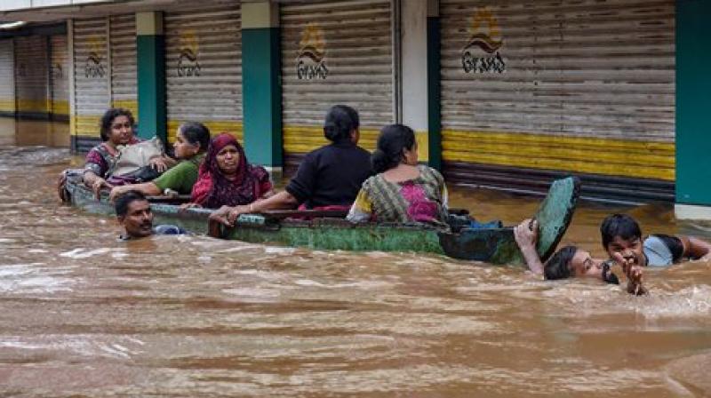 People being rescued from a flood-affected region following heavy monsoon rainfall, in Kochi. (Photo: PTI)