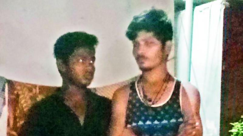 The two men who were caught by the locals and handed over to the police for capturing cats.