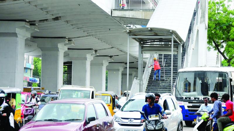 Metro staircases land right in the middle of the road, shrinking space for traffic.