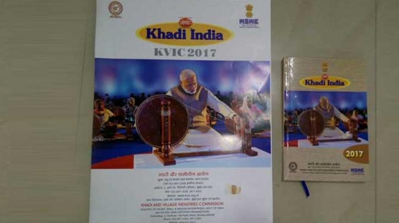PM Narendra Modi spinning the charkha on the 2017 KVIC calendar. (Photo: Twitter)