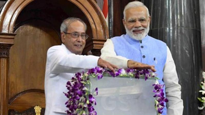 President Pranab Mukherjee and Prime Minister Narendra Modi press buttons for the launch of Goods and Services Tax (GST) at midnight, at the special ceremony in the Central Hall of Parliament in New Delhi on Saturday. (Photo: PTI)